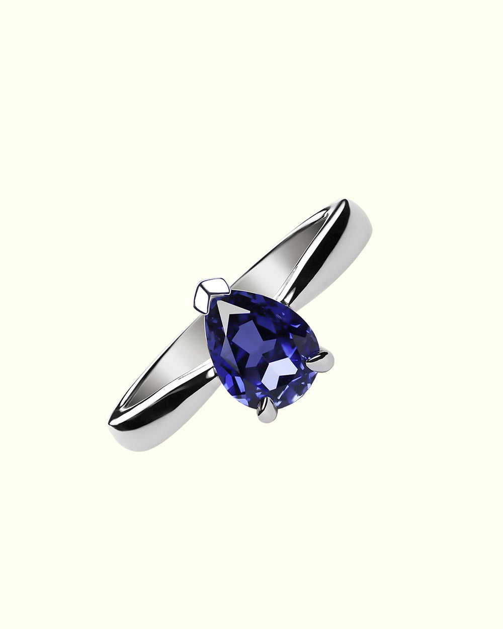 Chromia solitaire ring with blue sapphires